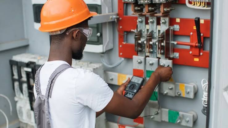 Electrician testing an industrial panel